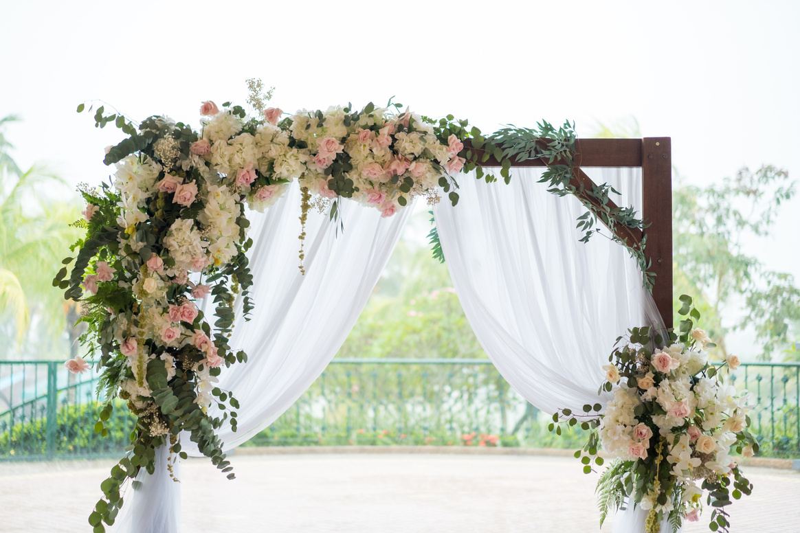Outdoor garden wedding ceremony flower arch